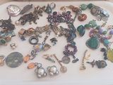 a tray with many different types of jewelry on it