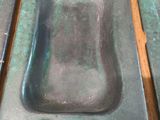 two green metal sinks sitting on top of a wooden table