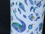a blue and white vase with a bird design on it