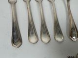 six spoons and a fork on a table
