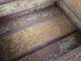 a rusted metal box with a metal handle