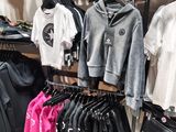 a lot of clothes that are on display in a store