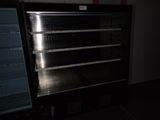 an empty refrigerator in a dark room next to a freezer
