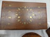 a wooden box with gold leaf designs on it