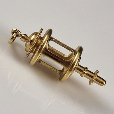 an image of a gold plated object on a white surface