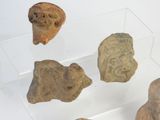 several pieces of pottery in a display case on a white surface