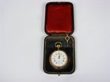 a small box with a pocket watch inside of it