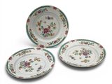 three plates with floral designs on them on a white surface