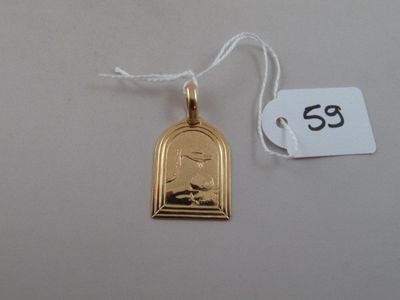 a gold pendant with a picture of a woman on it