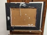 an old picture frame sitting on top of a wooden easel