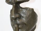 statue of a man with a finger on his lips