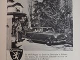 a black and white photo of a car parked in front of a gas station