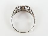 a close up of a ring on a white surface with a white background