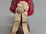 an image of a red and white hat with a bow on top of it