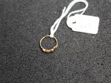 a close up of a gold ring with a tag on it
