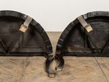 pair of vintage black leather and brass bookends on wooden floor