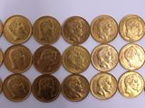 a lot of gold coins on a white surface