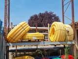 many different types of hoses stacked on a rack