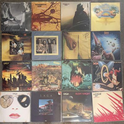a lot of different album covers on the floor