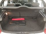 the trunk of a car with a red object in the trunk