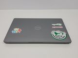 a laptop with stickers on it sitting on a table