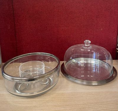 two glass dishes sitting on a table with a red background