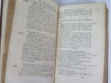 an open book on a table with a white background