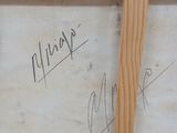 two wooden frames with writing on them sitting on top of a table