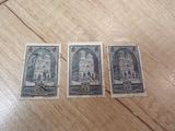 three stamps with a picture of a church on them sitting on a table
