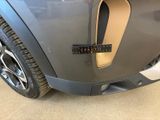 a close up of a car ' s front bumper with a hole in it