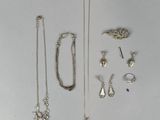 several different types of jewelry are displayed on a white surface