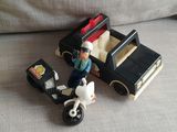 a toy motorcycle and a toy car with a police officer on it