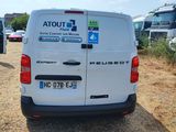 a white van that is parked on the side of the road