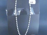 a black box with a white bead necklace on it