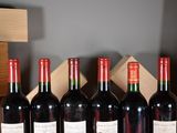 several bottles of wine are lined up in a row on a table