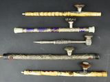 several different types of wooden and metal items on a black surface