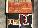 a box with a toy train inside of it on the floor