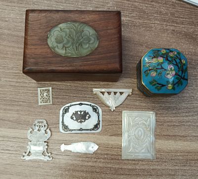 a wooden box that has various pieces of art on it