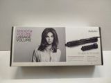a box with a hair dryer and a brush in it