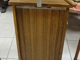 a wooden clothes rack with a coat hanger on it