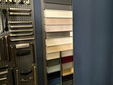 a picture of a bathroom with a toilet and a wall mounted tool rack