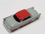 a toy car with a red top on a white surface