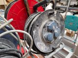 a hose and a reel on a rack in a room