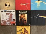 a lot of pink floyd album covers on the floor
