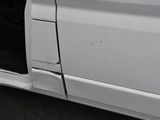a white truck with a broken door and a black door handle