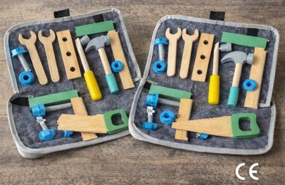 two suitcases with tools in them on a wooden table