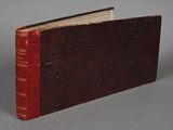 a book with a red cover sitting on a table