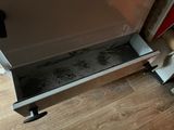 a drawer that is open on the floor in the kitchen