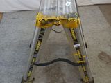 a ladder that is sitting on the floor in front of a white wall