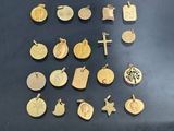 many different types of gold pendants on the table